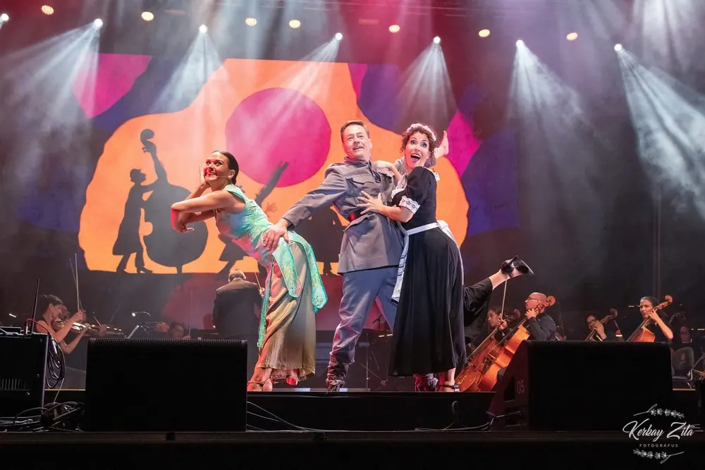 Dancers on stage with the projected illustrated backdrop behind them